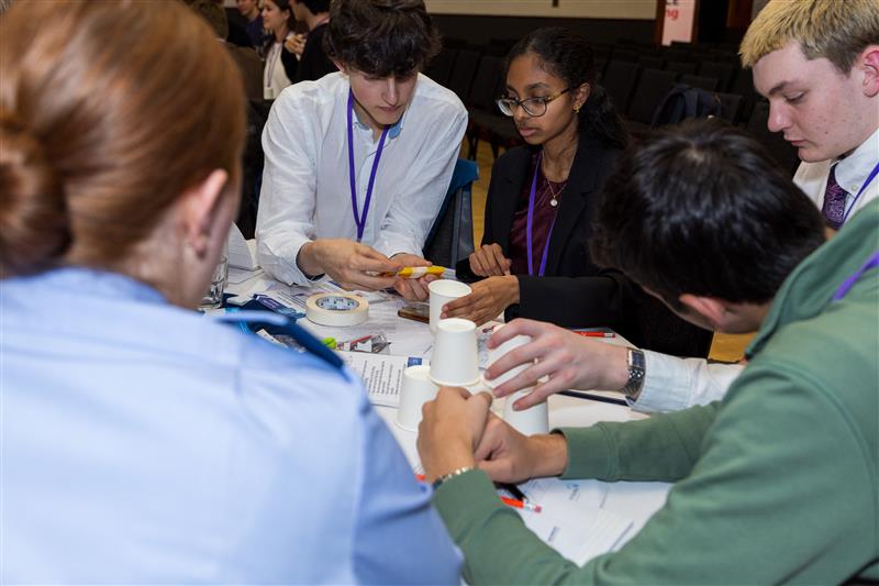 Young people sitting round a table engaging in task for RAFCT scholarship