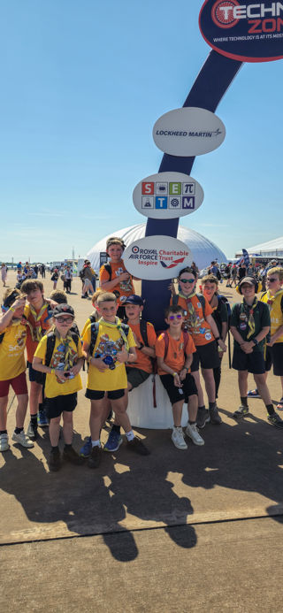 Children standing around one of the arch pillars for the Techno Zone sign at RIAT24