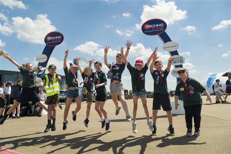 Scouts jumping in the air in front of the Techno Zone arches at RIAT24
