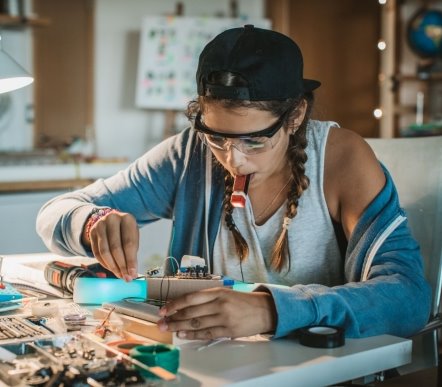 Older girl pupil taking part in an experiment for Arkwright Engineering Scholarships for RIAT24