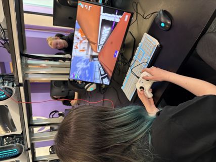 Race to RIAT girl playing on esports screen#.
