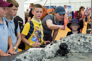 Boys looking at a space scape model in the Techno Zone at RIAT24