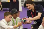 Two boys being shown a model for Road to RIAT at RIAT24