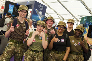Young people standing in the Techno Zone at RIAT24 with their thumbs up