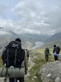 Group of young people carrying rucksacks in a rural landscape