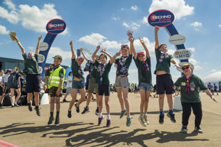 Children jumping in front of Techno Zone sign at RIAT24