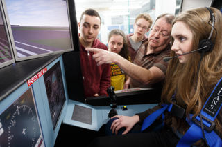 Girls and boys watching a simulation screen with an instructor for an EDT school activity for RIAT24
