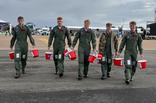 Members of the RAF carrying collection buckets at RIAT24