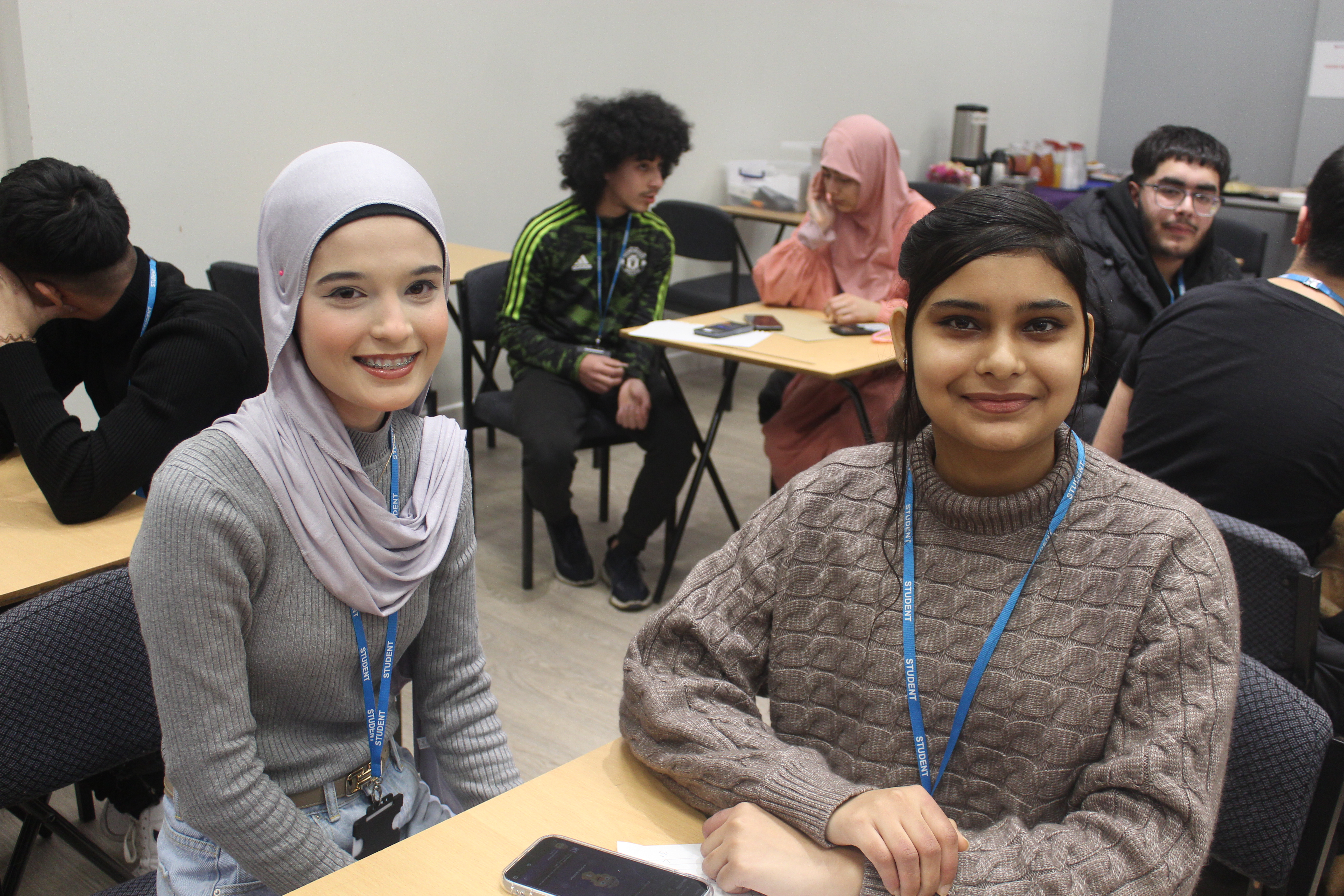 Further education maths challenge students looking at the camera.