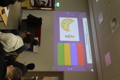 Further education maths challenge students with screen.
