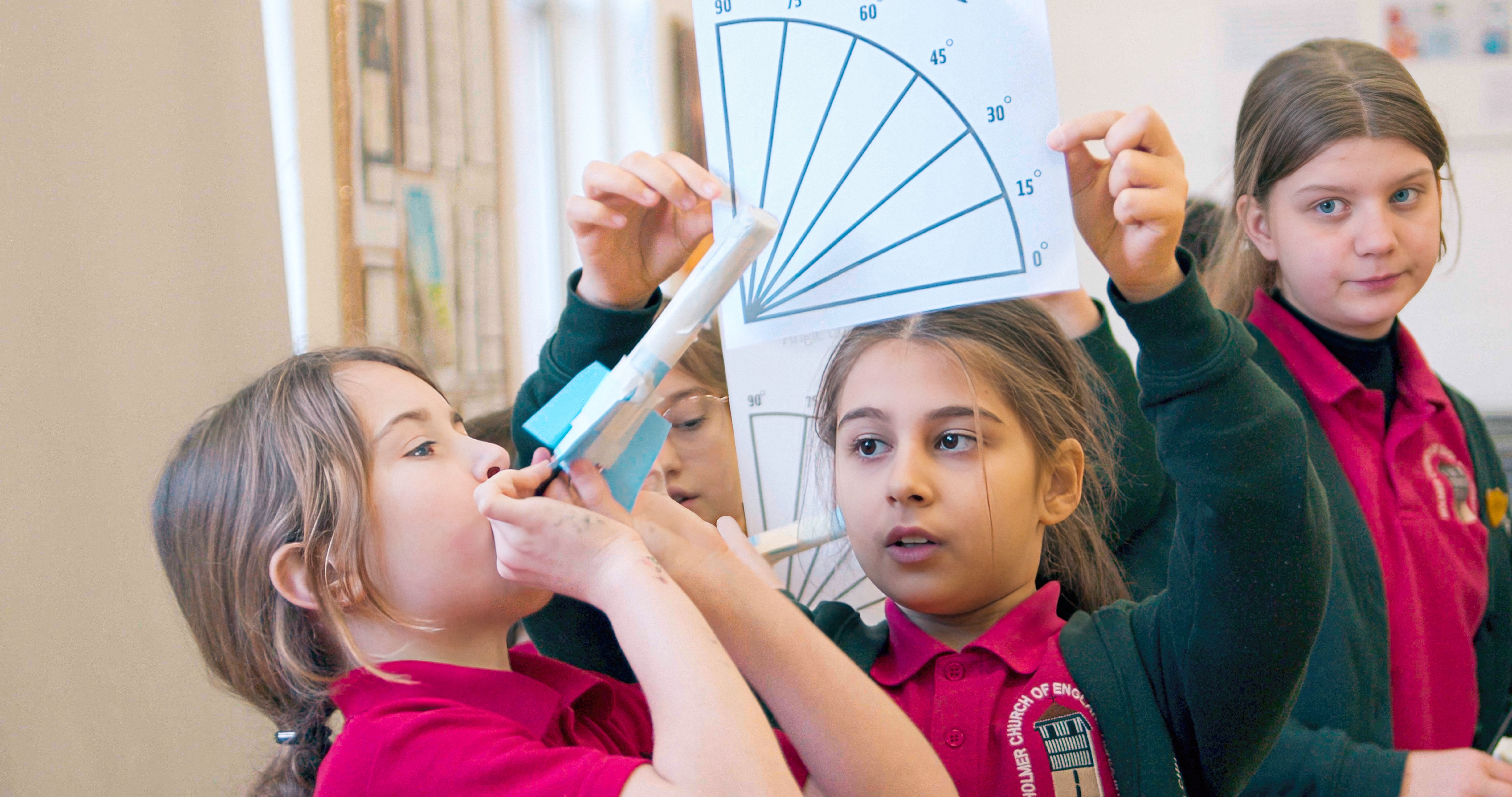 Girls launching a paper rocket for the Road to RIAT competition for RIAT24