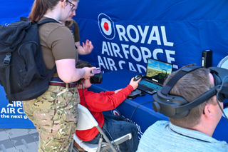 Boy and instructor in the Royal Air Force Cadets tent with a virtual reality headset