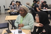 Further education maths challenge students sitting at desks.