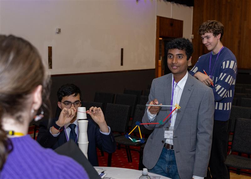 Arkwright Engineering scholars standing up taking part in an experiment