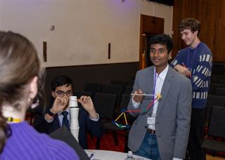 Arkwright Engineering scholars standing up taking part in an experiment