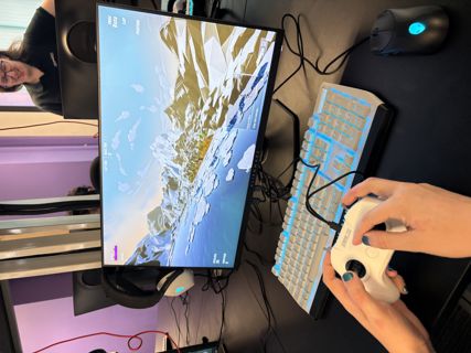 RACE to RIAT gaming screen with girl's hands and keyboard.