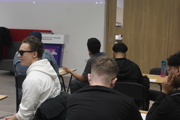 Further education maths challenge students at desk.