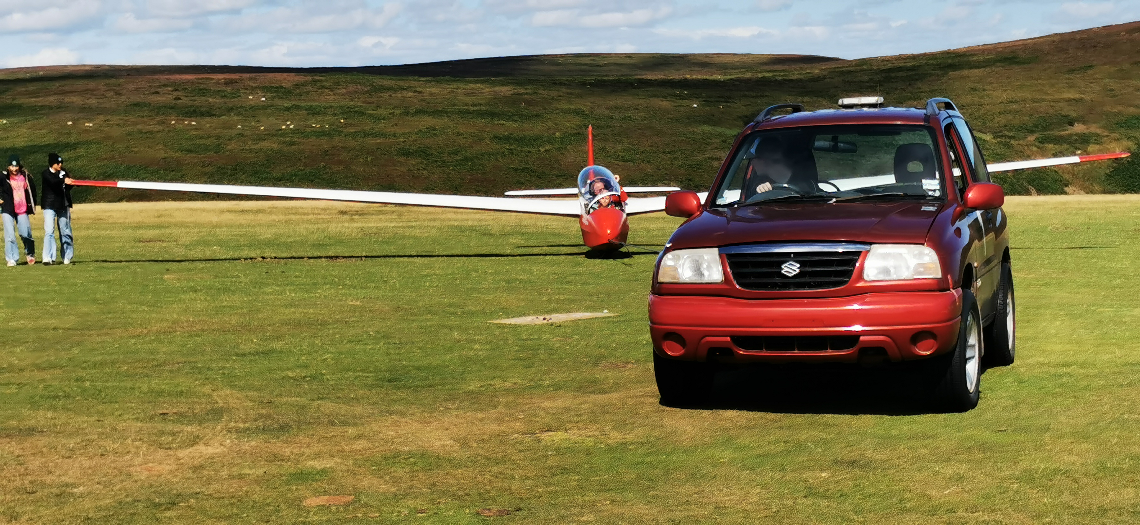 Noah retrieving with a glider in the background