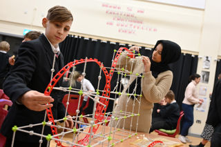 Boy and girl building a model for EDT schools activity for RIAT24