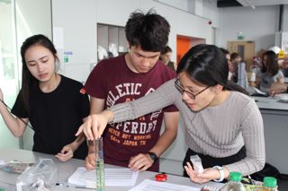 A couple of girls and a boy taking part in an experiment for EDT school activities for RIAT24